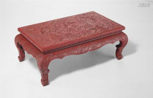 A Chinese red lacquer 'Kang table'. Late 19th century. H. 30 cm. L. 83 cm. W. 52 cm.