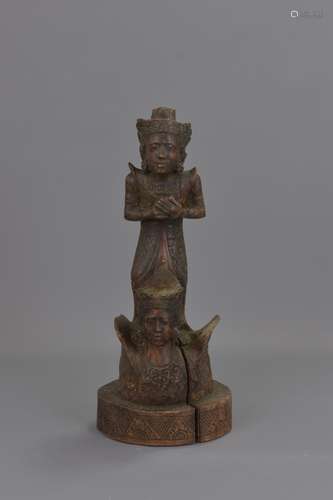 A FAR EASTERN CARVED WOODEN FIGURE