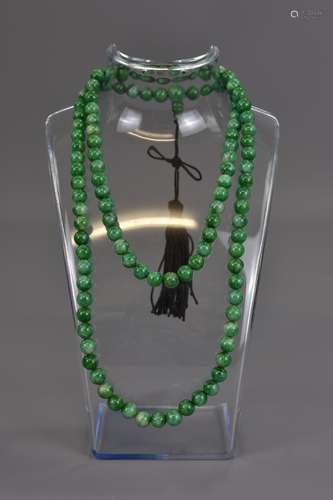 A CHINESE JADEITE BEADED NECKLACE