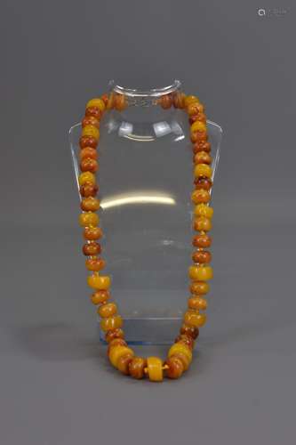 AN AMBER BEADED NECKLACE