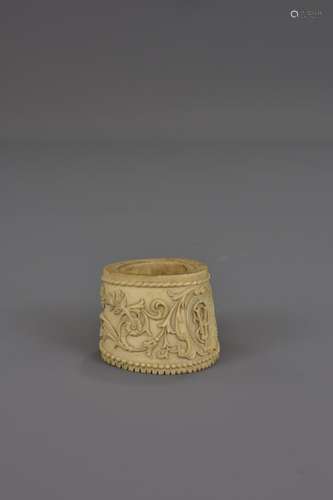 AN ASIAN CARVED BONE NAPKIN RING