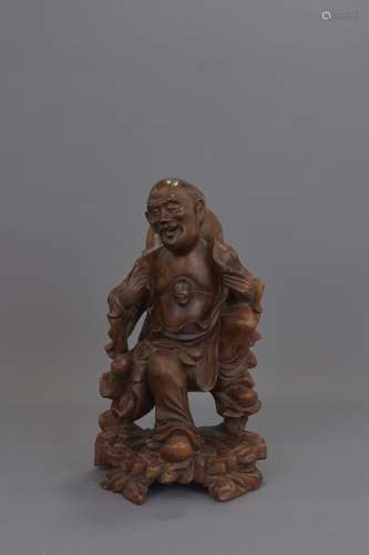 A CHINESE CARVED WOOD FIGURE OF IMMORTAL