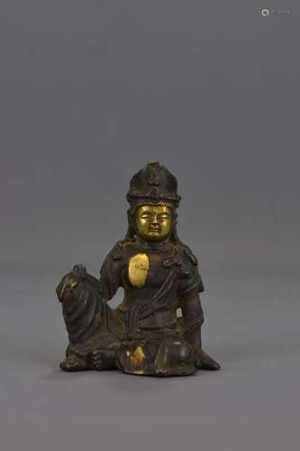 A CHINESE BRONZE SEATED FIGURE