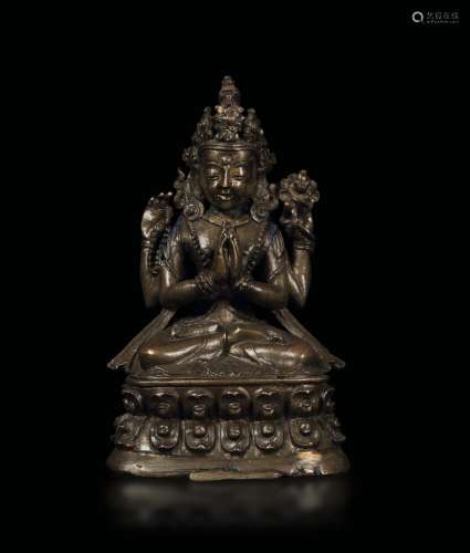 A bronze figure of Shadakshari seated on a double lotus flower, Tibet, 16th century