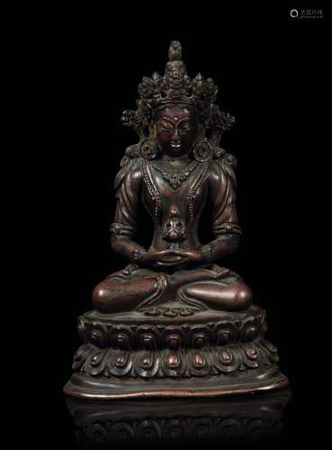 A bronze figure of Avalokitesvara seated on a double lotus flower, Tibet/Nepal, 16th century