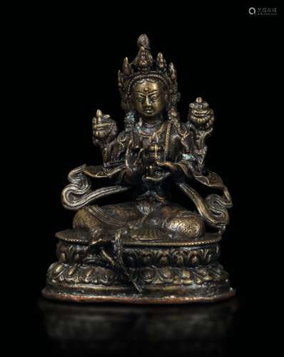 A bronze figure of Avalokitesvara seated on a double lotus flower, Tibet/Nepal, 15th century