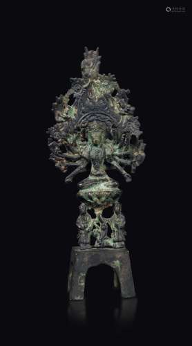 A bronze figure of Buddha seated on a lotus flower on a pedestal with an aura, China, Northern Wei Dynasty (386-534)