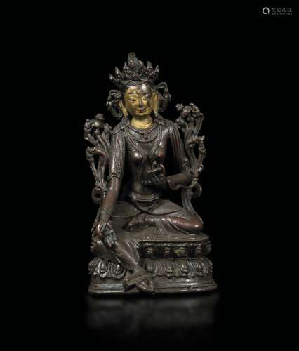 A semi-gilt bronze figure of a Green Tara seated on a double lotus flower, Tibet, 18th century
