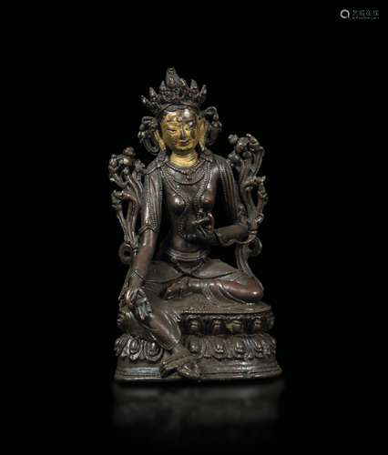 A semi-gilt bronze figure of a Green Tara seated on a double lotus flower, Tibet, 18th century