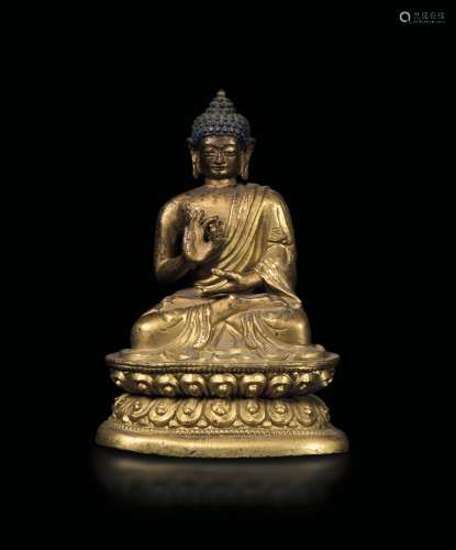 A gilt bronze figure of Buddha Sakyamuny seated on a double lotus flower, Tibet (?), 17th-18th century