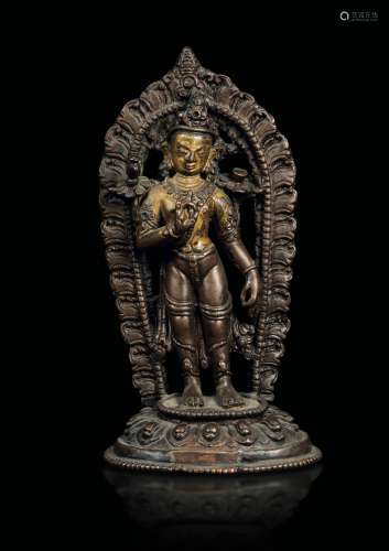 A semi-gilt bronze figure of Padmapani with aura seated on a lotus flower, Tibet, 11th-12th century
