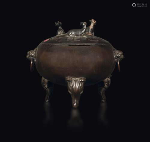 A tripodal bronze censer with elephant head-shaped legs and a goat-shaped handle, China, Qing Dynasty, 18th century