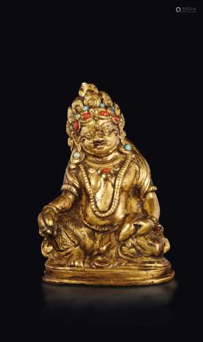 A gilt bronze figure of Sita-Jambhala with coral and turquoise inlays, Tibet, 16th century