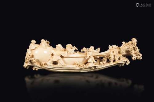 A carved ivory group with figures of fishermen on a fantastic vessel, China, early 20th century