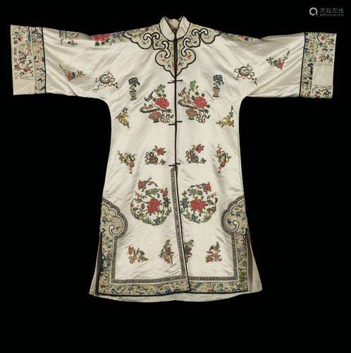 A white-ground silk dress embroidered with a naturalistic motif, China, early 20th century