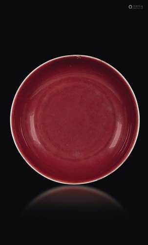 A monochrome oxblood porcelain plate, China, Ming Dynasy, Xuande period (1426-1435)