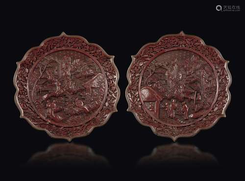 A pair of red lacquer plates with a decor of wisemen in a landscape, China, Qing Dynasty, 19th century