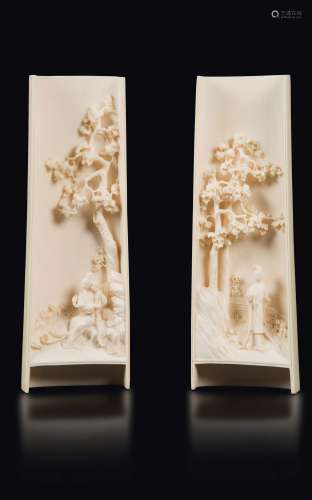 A pair of carved ivory wrist rests with Guanyin figures in a landscape, China, early 20th century
