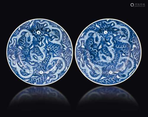 A pair of blue and white porcelain vases with a decor of five dragons in the clouds, China, Qing Dynasty, Kangxi period (1662-1722)