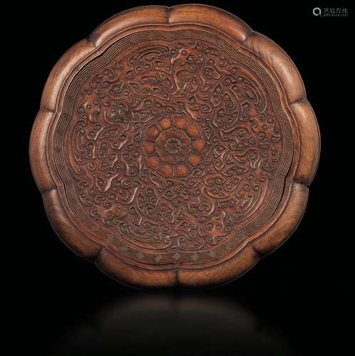 A polylobe box in carved huanguali wood with a central flower and a cloud motif, China, Qing Dynasty, Qianlong period (1736-1796)