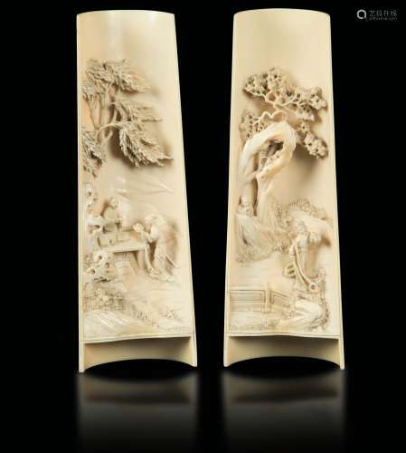 A pair of carved ivory wrist rests with wisemen figures in a landscape, China, early 20th century