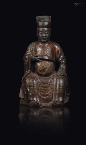 A figure of a seated dignitary in lacquered and guilt wood, China, Ming Dynasty, 16th century
