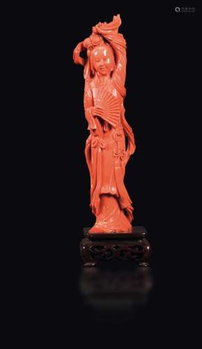 A carved coral Guanyin with a fan, China, Qing Dynasty, late 19th century