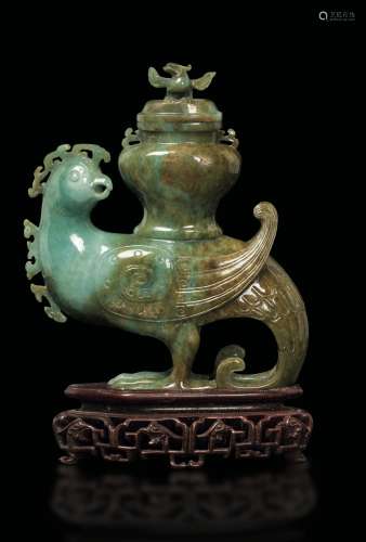 A carved green and russet jade vase held up by a phoenix, China, early 20th century