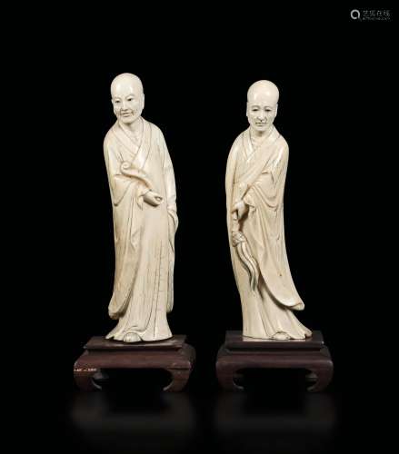 A pair of carved ivory Luohan figures with ritual tools, China, early 20th century