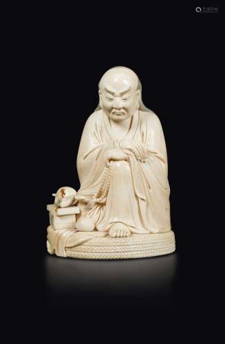 A carved ivory figure of a seated wiseman with prayer beads, China, 20th century
