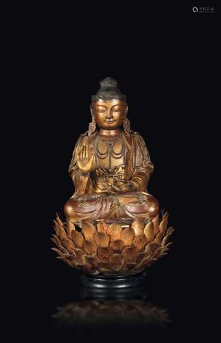 A lacquered and gilded wood Buddha figure seated on a lotus flower, China, Ming Dynasty, half of the 17th century