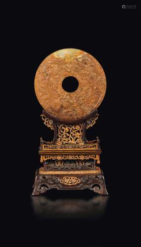 A rare white and russet jade Bi disk, finely carved with a Qing homu wood stand, China, Western Han Dynasty (206 BC-26 AD)