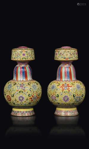 A pair of Pink Family porcelain vases with a baijixiang yellow backdrop and depictions of the eight Buddhist symbols, China, Republic, 20th century