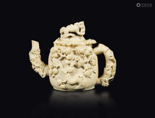 A carved ivory teapot with a peach decor and a monkey lid, China, early 20th century