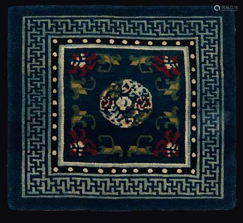 A meditation mat with a central medallion on a blue backdrop, China, 1900 ca.