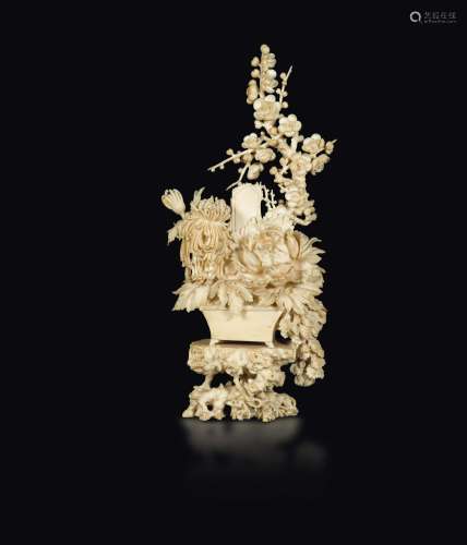 A carved ivory group depicting a vase with flowers, China, early 20th century