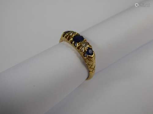 An Antique 18 ct Yellow Gold Sapphire and Diamond Ring, one oval sapphire 4 x 3 mm, 2 x 2.75 mm, size M, approx 9pts old cut dias, approx 3.1 gms.