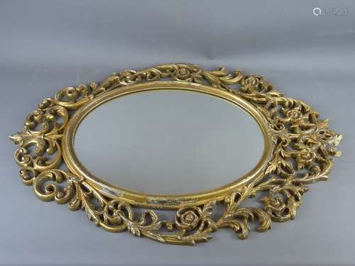 An Oval Gilt-Style Mirror, with decorative carving to the frame.