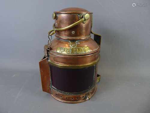 An Antique Copper Ship's Oil Lamp, having Red/Blue glass and 'Starboard' and 'Port' plaques to sides, hinged chimney top and brass carry handle, approx 22 cms high together with an antique copper firescreen, with decorative sphere to top and horseshoe-shaped supports, approx 54 x 61 cms.