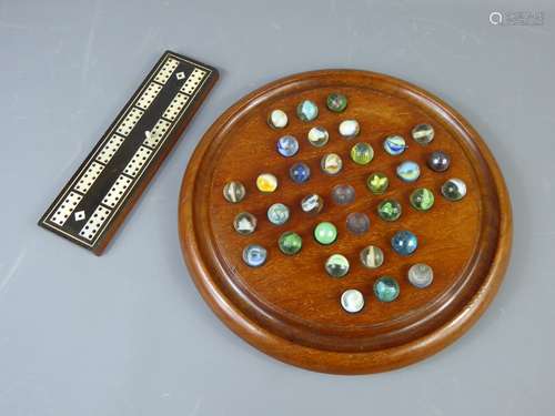 A 19th Century Mother of Pearl Cribbage Board and Edwardian bun-footed Solitaire board.