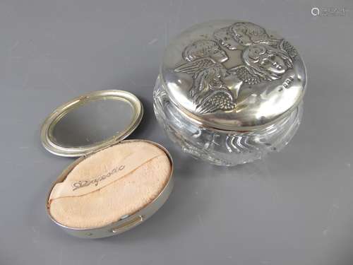 An American Silver Compact, oval with engine turned decoration, together with a silver topped cut glass powder bowl. (2)