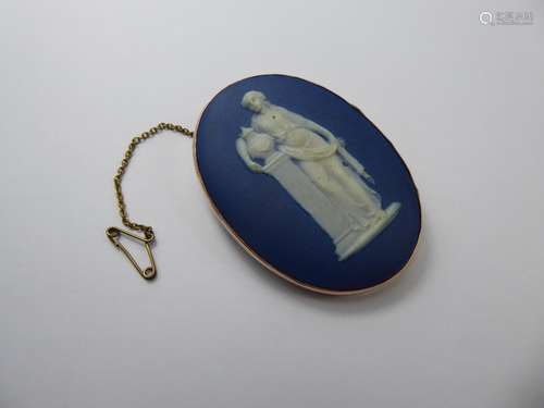 An Antique Oval 9 ct Blue Porcelain Wedgwood Brooch, the brooch mounted in 9ct gold frame, depicting a classical figure, approx 52 x 40 mm, approx 29 gms.