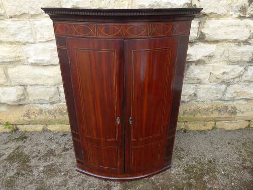 A Georgian Mahogany Bow-Fronted Corner Cupboard, with two internal shelves, approx 105 x 29 x 45 cms (straight sides).