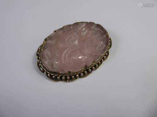 A Chinese Hand Carved Silver Gilt and Rose Quartz Brooch, carved with peony in silver beaded mount, approx 55 x 40 mm.