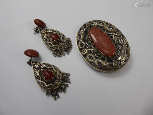 A Chinese Silver-Metal and Gold-stone Glass Brooch and Earrings, approx 67 x 50 mm and the earrings approx 42 x 24 mm, set in floral mount depicting serpents.