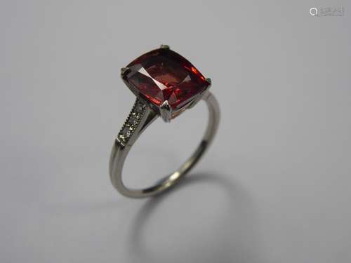 A 3.48 ct Natural Blush Red Spinel and Diamond Ring, reputedly of Burmese origin, the rectangular cushion-cut stone measuring 10.1 x 7.9 x 4.5 mm and flanked by three dias 8 pts dias and set in a platinum mount.  Gem and Pearl Certificate nr 15672 dated 04/05/18, no evidence of heat treatment observed. Presented in a Asprey's London box.