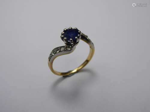 An Antique Yellow and White Gold Sapphire and Diamond Ring, size M, approx 2.9 gms, the sapphire approx 6.4 x 5.8 x 2.6 mm, approx 0.83 ct, ten rose cut dias, approx 0.12 ct.