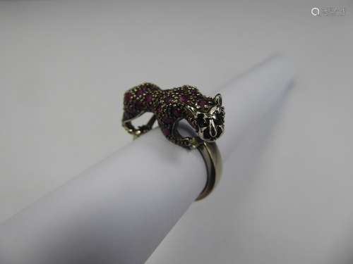 A Silver Panther Ruby and Sapphire Ring, 2 x 1mm black dias, 36 rubies, size O, approx 10.6 gms