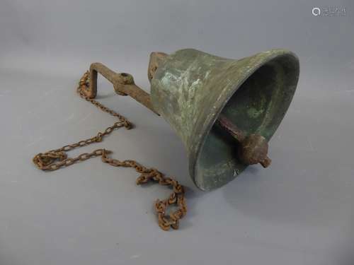 An Antique Bronzed Bell, suspended on a metal rod supported with chain. The timber arm is approx 62 cms long, the chain is approx 9 x 23 cms long.