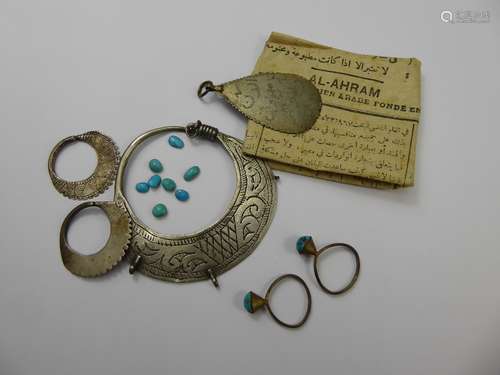 Two Antique Egyptian Turquoise Rings, together with loose turquoise stones, and miscellaneous antique near Eastern engraved jewellery including silver earrings and a white metal brooch and pendant.